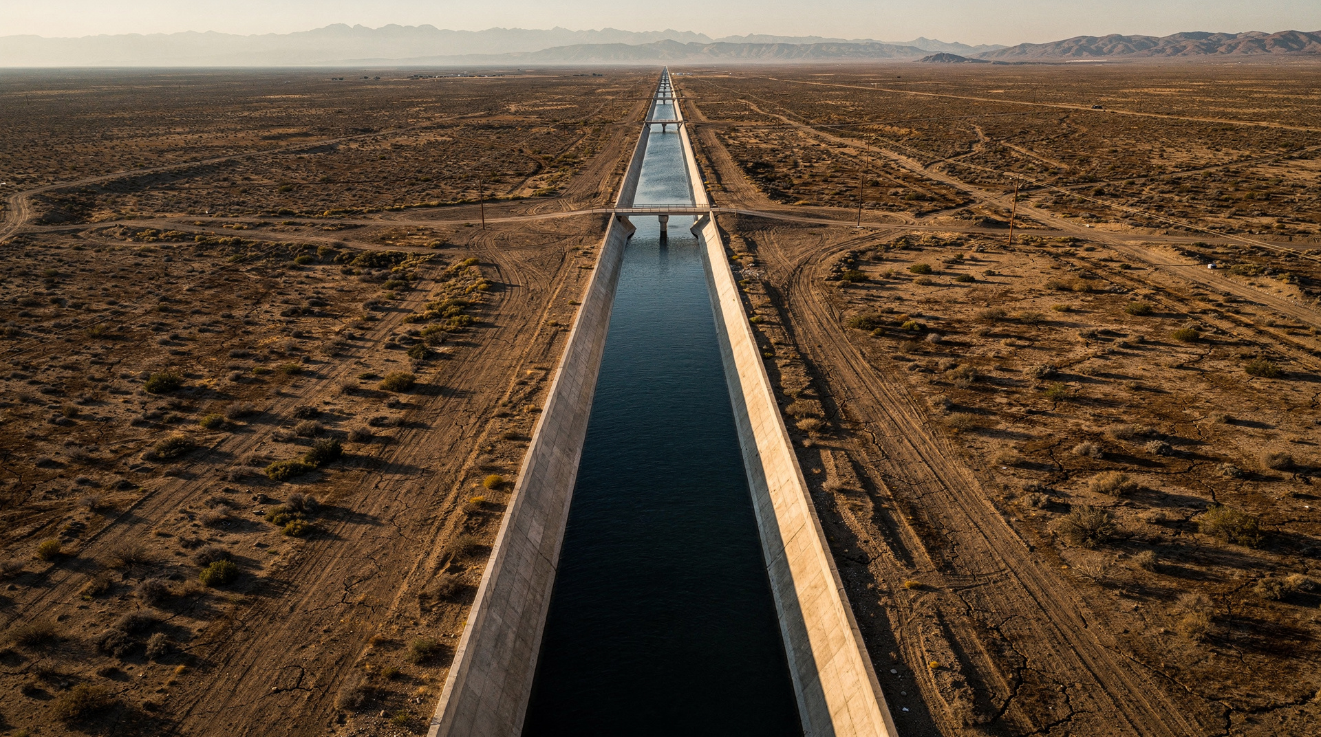 A water pipeline across a desert, with its energy cost rendered as a bar chart